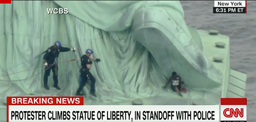 Woman Arrested on 4th of July After Climbing the Base of the Statue of Liberty in Protest of Migrant Family Separations Woman Arrested on 4th of July After Climbing the Base of the Statue of Liberty in Protest of Migrant Family Separations