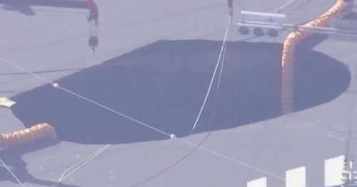 Swimming pool-sized sinkhole traps truck driver in Japan